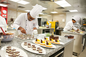 Two chefs in a Richemont master baker commercial kitchen preparing desserts